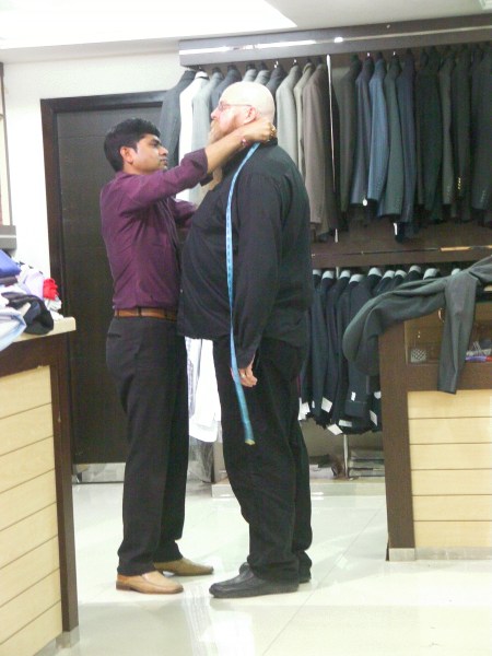 tailor measuring man for a suit