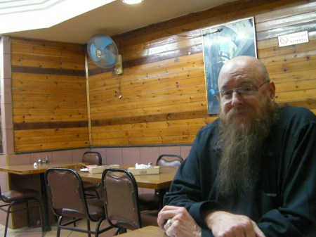 man in a wood panelled restaurant
