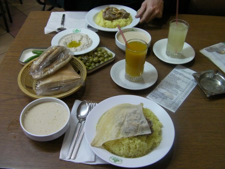 dishes of rice, meat, bread, moutabel, mango juice, lemon juice