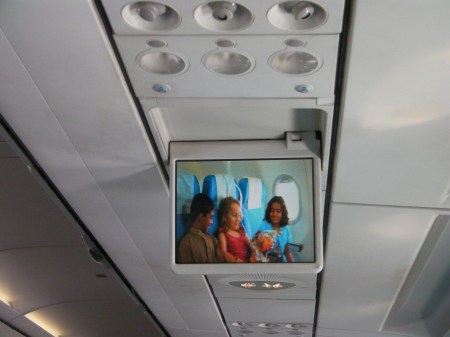 airplane drop down screen showing safety video