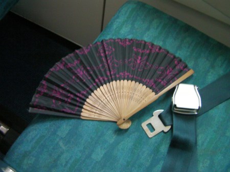Japanese style fan on an airplane seat