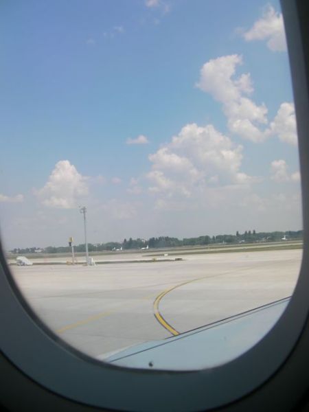 view out the airplane window at the runway