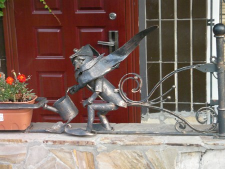 ironwork sculpture - bearded man with watering can