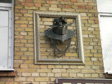 ironwork sculpture - knight's helmet mounted on the side of the building