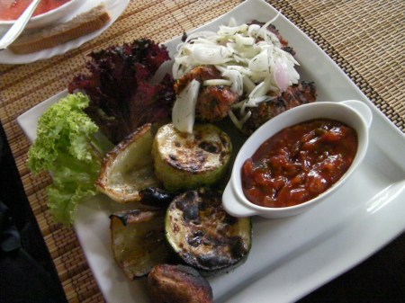 pork meat, grilled squash, and tomato sauce