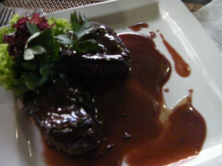 two pieces of beef steak with wine sauce