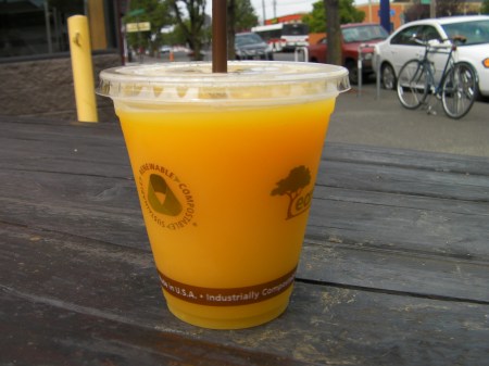 orange juice in a plastic cup