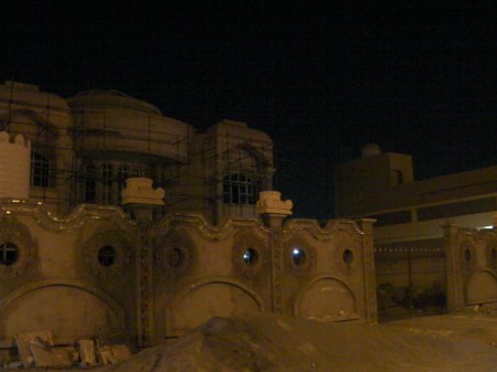 cement fence with upside down ionic capitals attached
