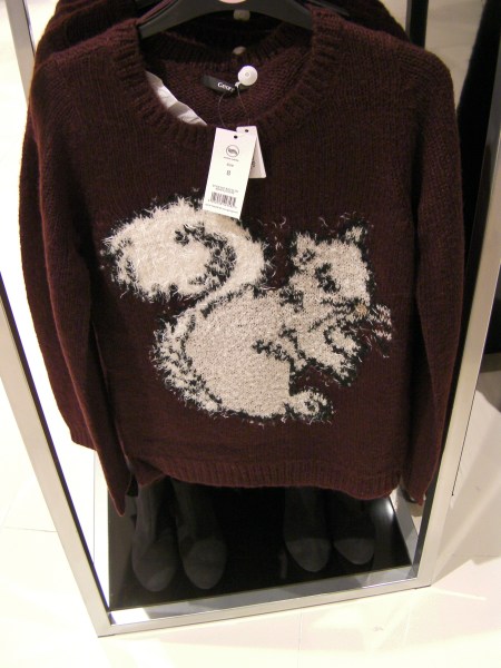 brown sweater with a cream colored squirrel on it