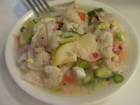 salad with fish, cucumbers, onions, lemon, turnip, and vinegar
