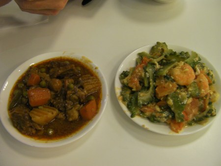 two plates, one with a beef dish and the other with a shrimp dish