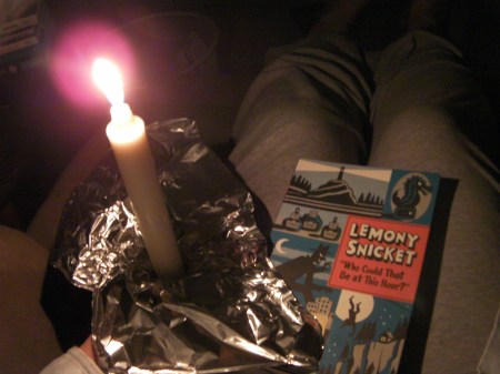 a book, candle, and make-shift aluminum candle holder
