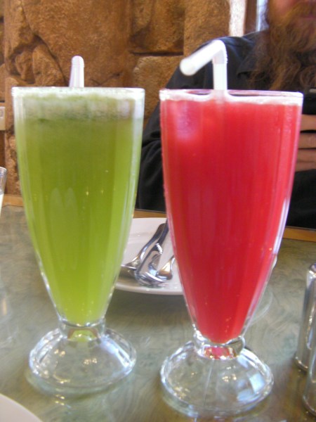 a glass of watermelon juice and a glass of lemon and mint drink