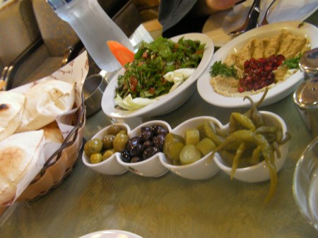 rocket salad, mutabel, bread, and olives