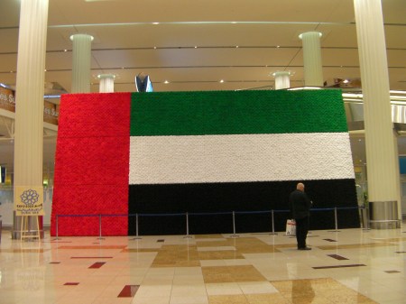 red, green, white, and black flag approximately 18 feet tall