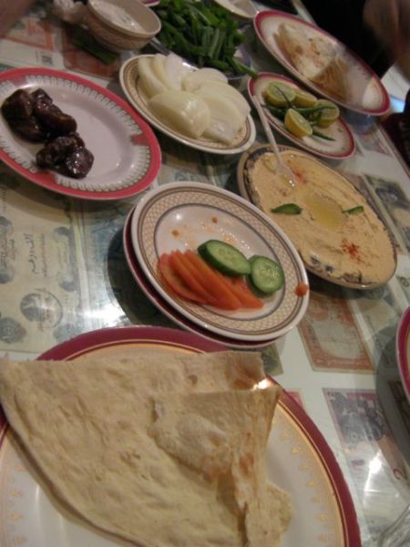 plates of dates, hummous, carrots, cucumbers, onions