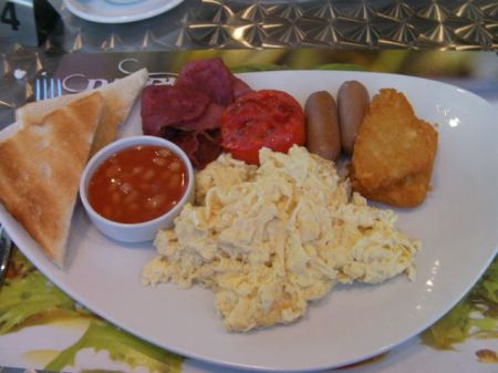 scrambled eggs, potato patties, link sausage, fried tomato, beans, toast, beef bacon