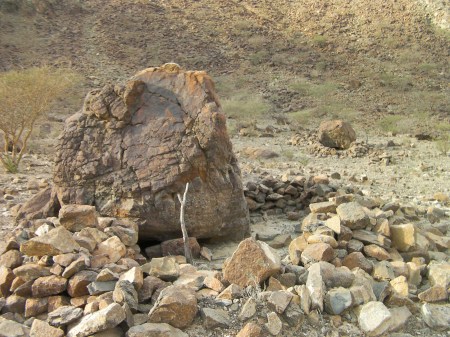 large boulder with a low rock wall built around it