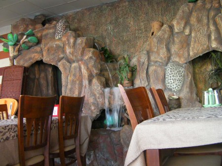 artificial rock-face waterfall inside the restaurant