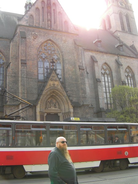 man in front of a tram in front of a church