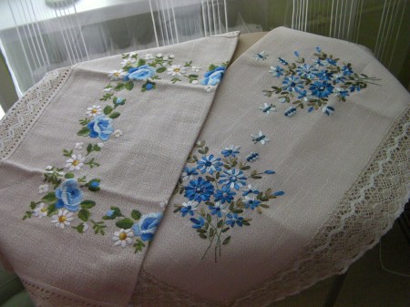 two table cloths embroidered with blue flowers