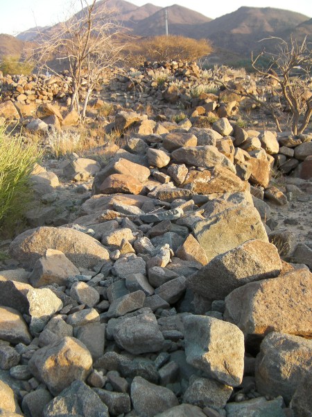 rock wall made of two rows of large stones with smaller stones filling the gap between