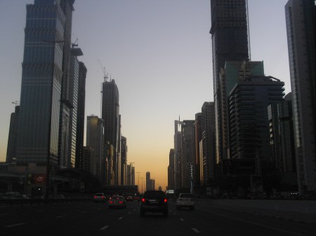 highway between two rows of skyscrapers