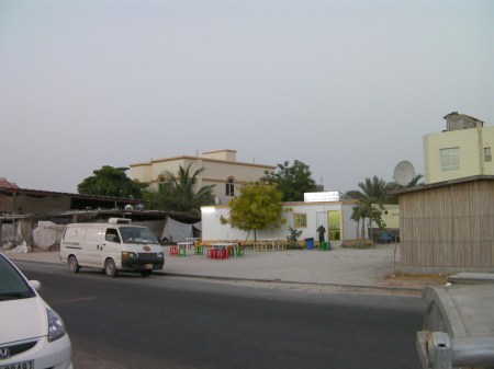 modular building in a sand lot which houses a fish restaurant