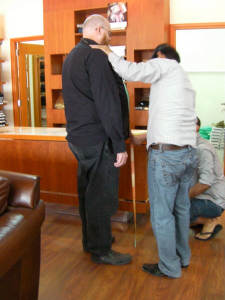 tailor measuring a customer