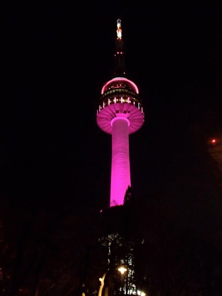 communications tower at night lit up pink