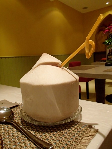 a coconut with a straw sticking out