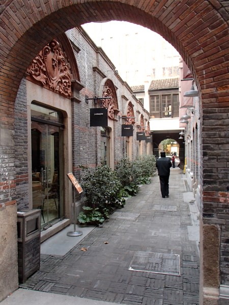 narrow lane between brick buildings