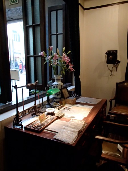 desk with abacus, papers, other items as museum display