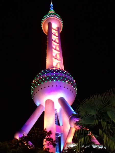 tower lit in multiple colors at night