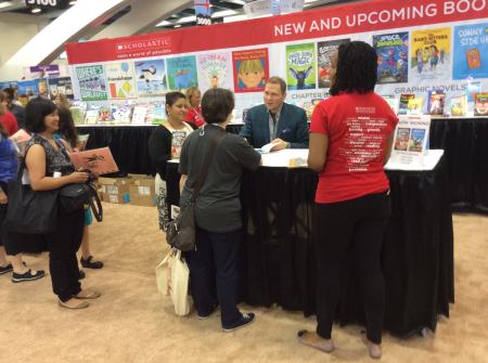 Dav Pilkey at the Scholastic Books booth signing books