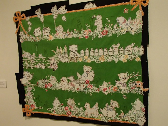 Hanging art quilt made with embroidery cut from tea towels and pillow cases