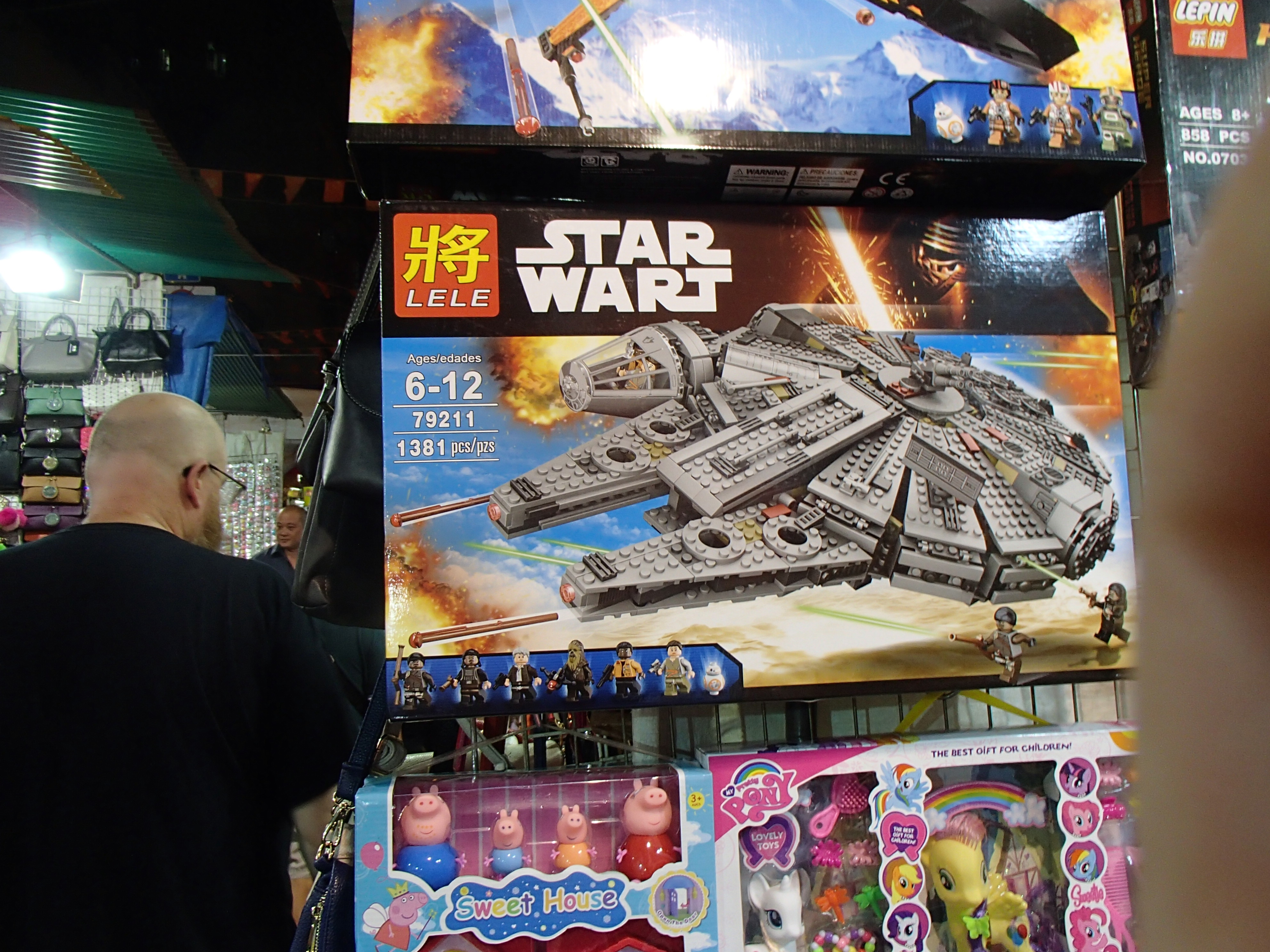 toy boxes, one of which is a Star Wart version of the Millennium Falcon