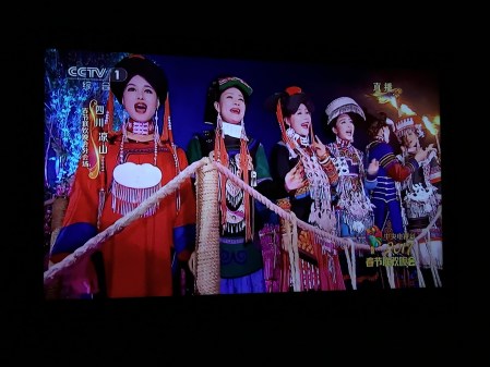 Chinese women in traditional ethnic dress singing