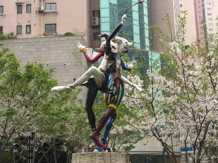 statue of two harlequin clowns