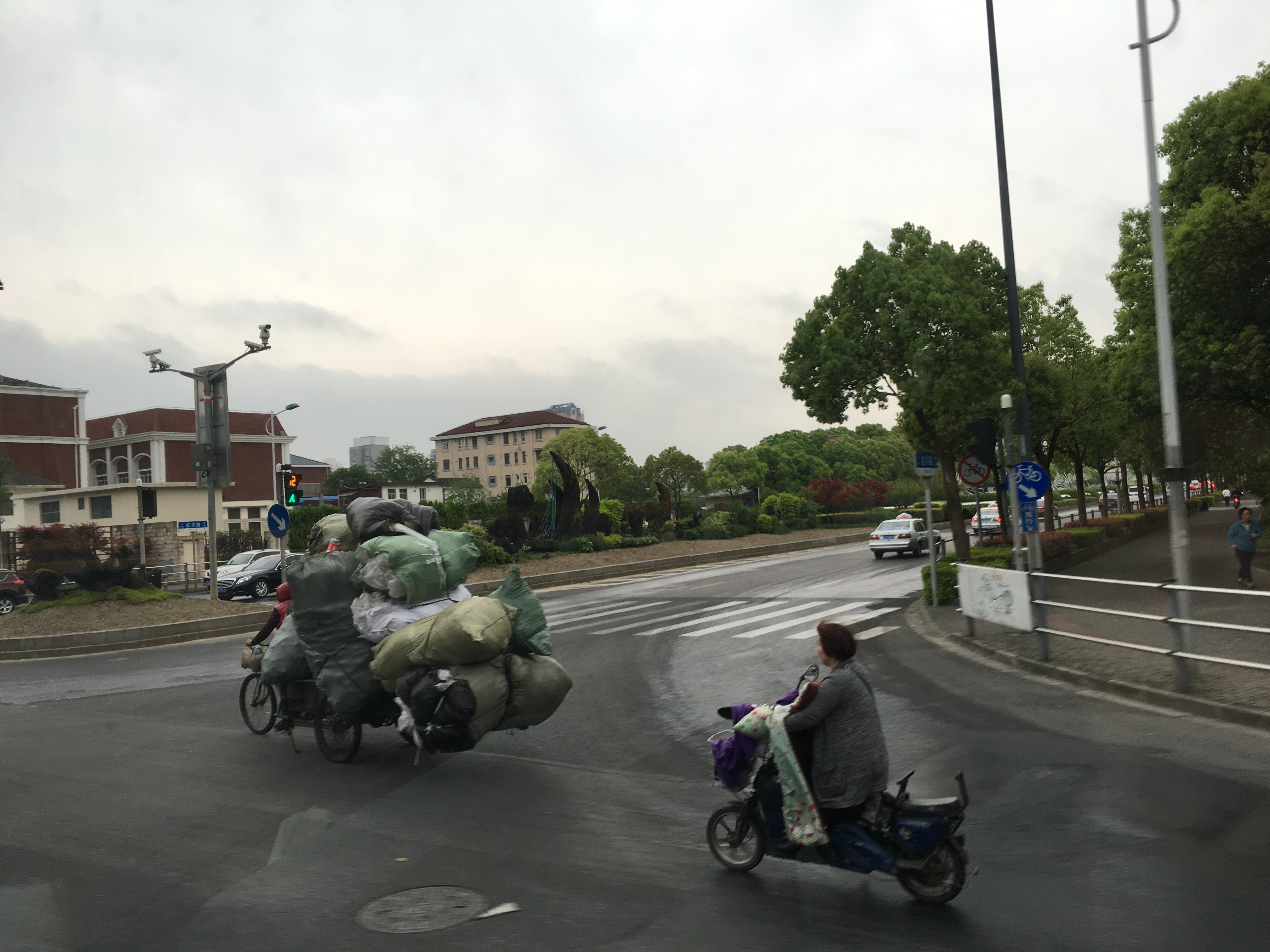 three wheeled cycle loaded with recyclables