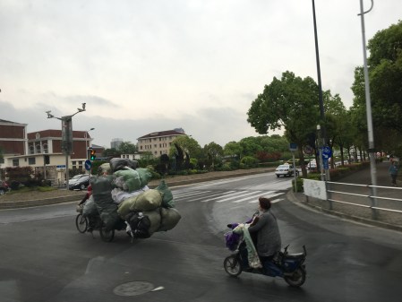 three wheeled cycle loaded with recyclables