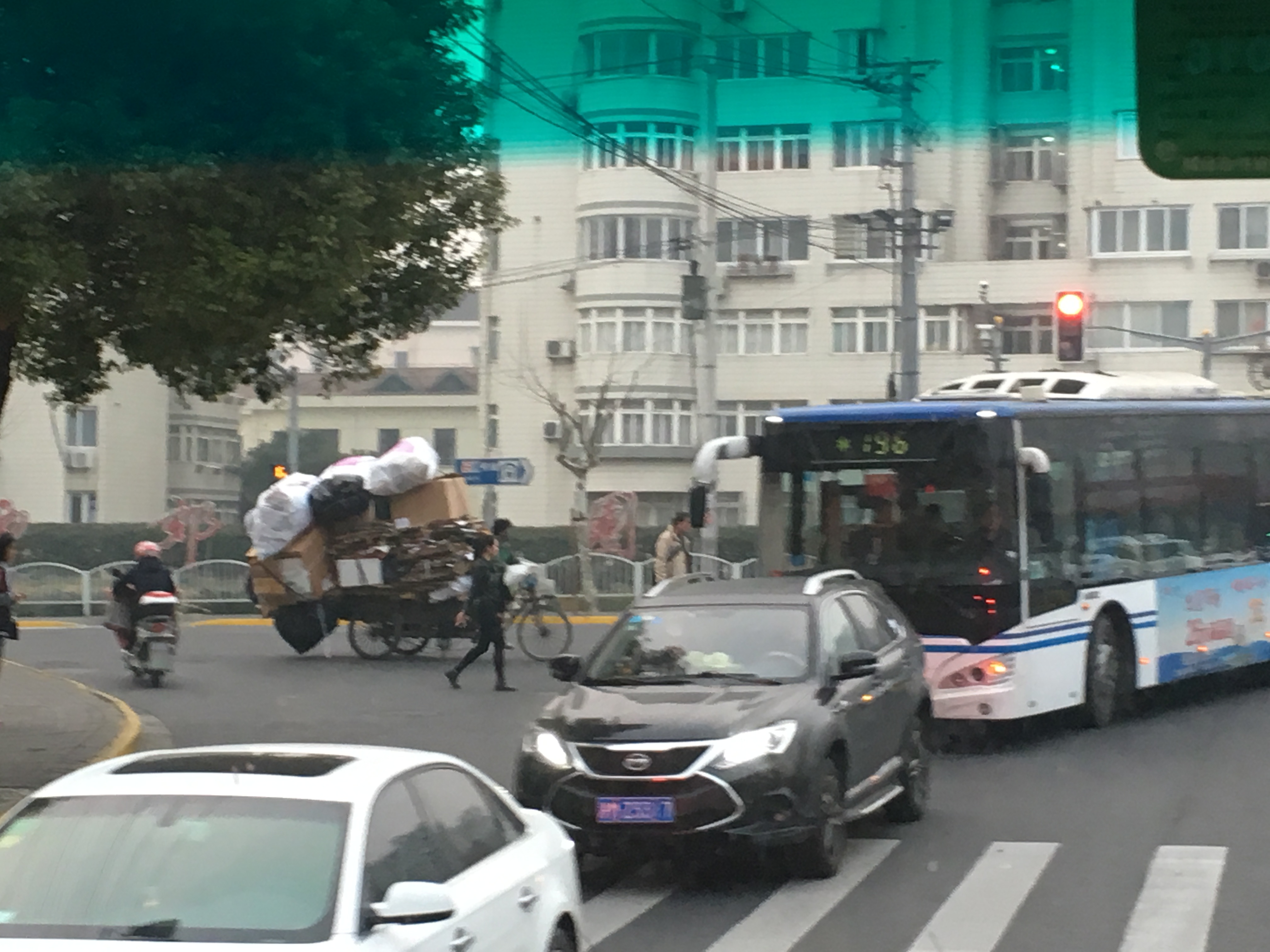 cars, bus, three wheeled cart, and chaos
