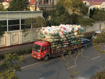 large truck filled with about two stories worth of plastic bottles