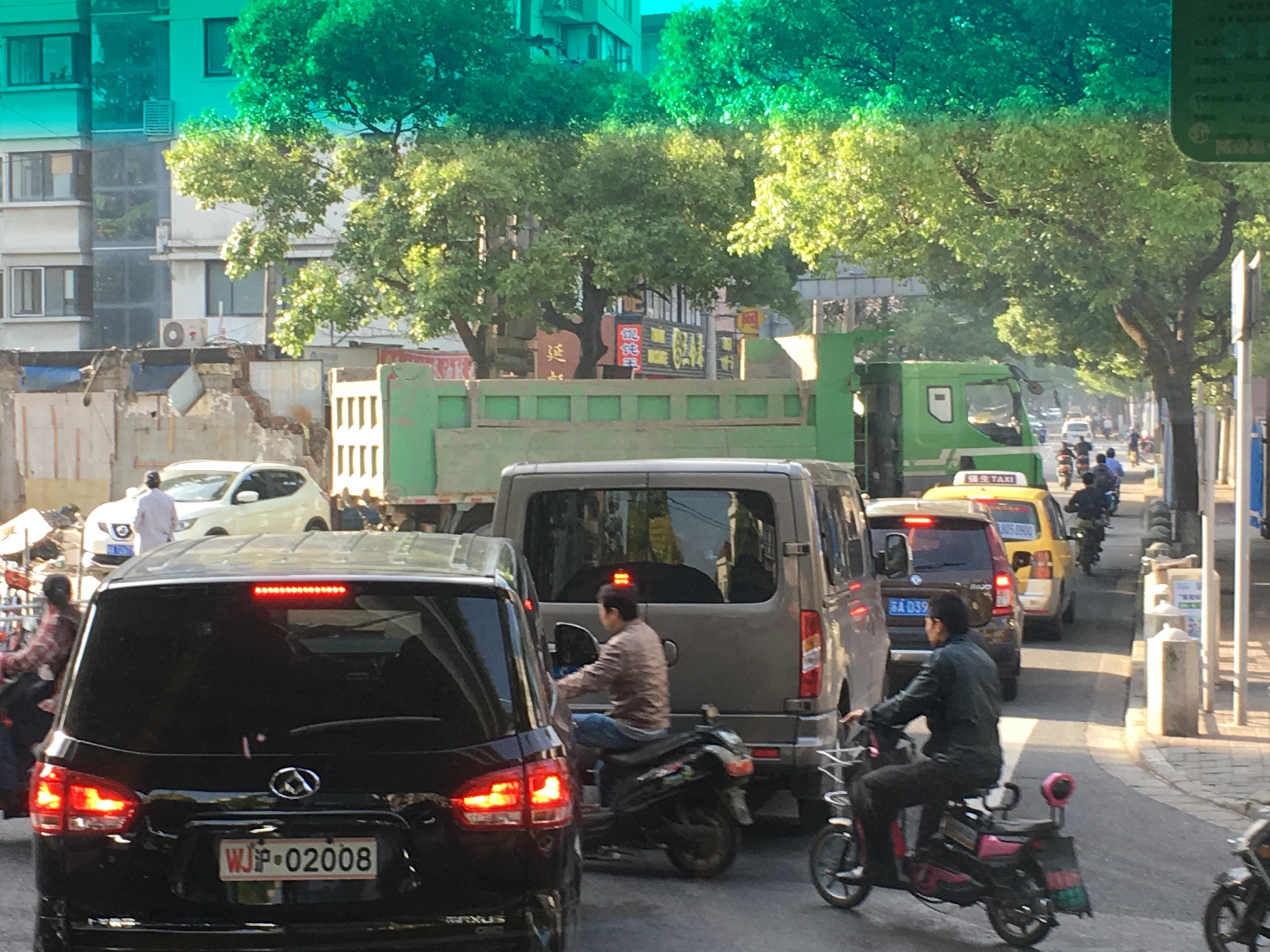 traffic blocked by a large green truck