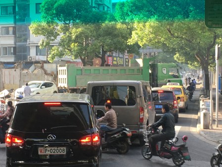 traffic blocked by a large green truck