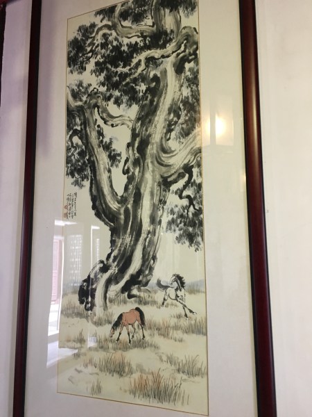Chinese watercolor painting of a tree and two horses