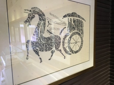 rubbing of a horse drawing a carriage