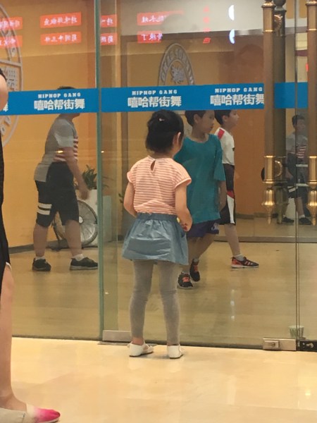 girl looking into dance studio 