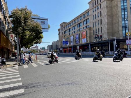 scooter and bicycle traffic at an intersection