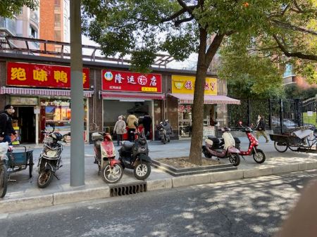 small businesses, sidewalk, people lined up at a food stall